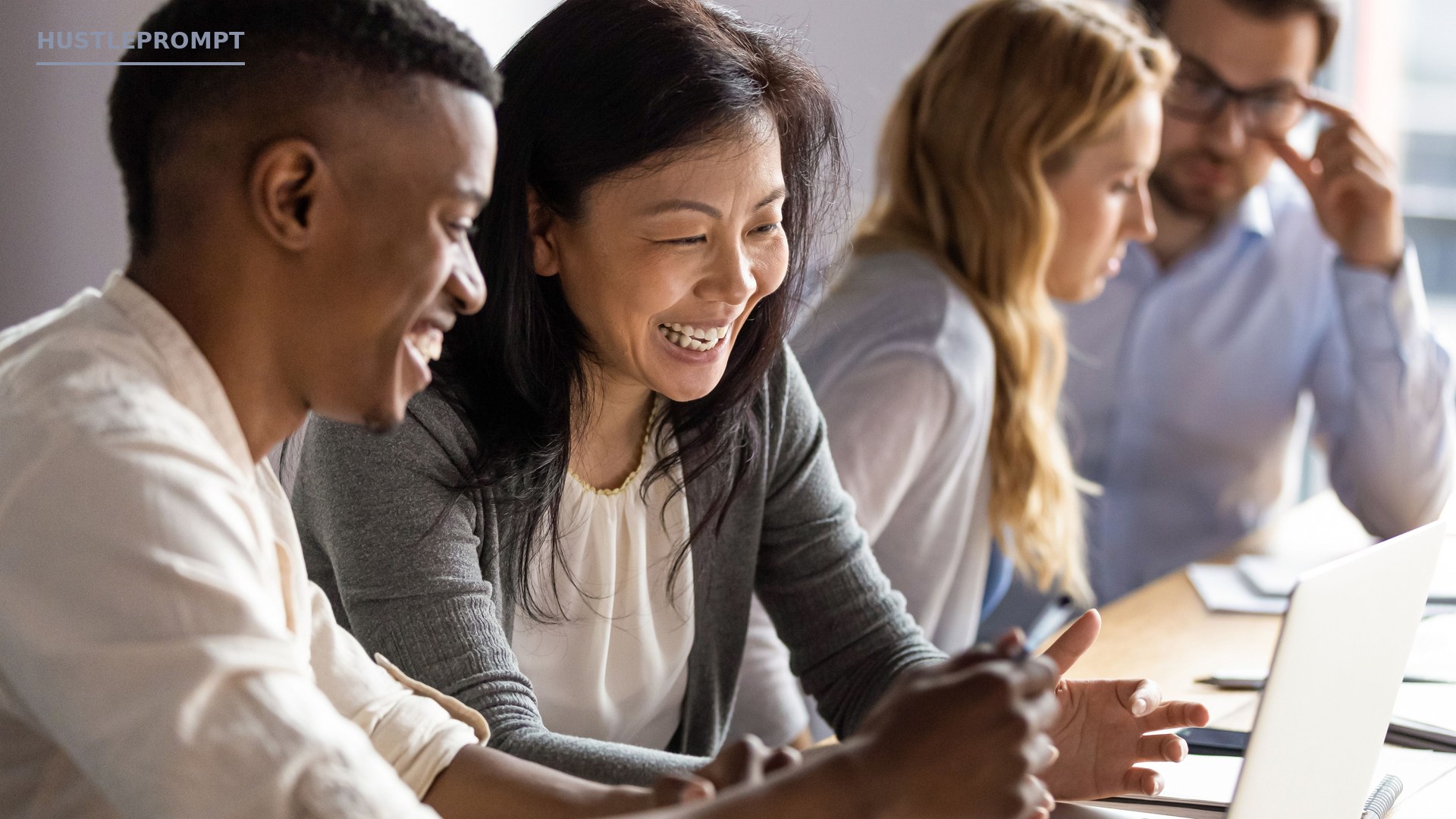 Team of professionals collaborating around a laptop — cover image from Microsoft's official announcement of five new Copilot features in Excel